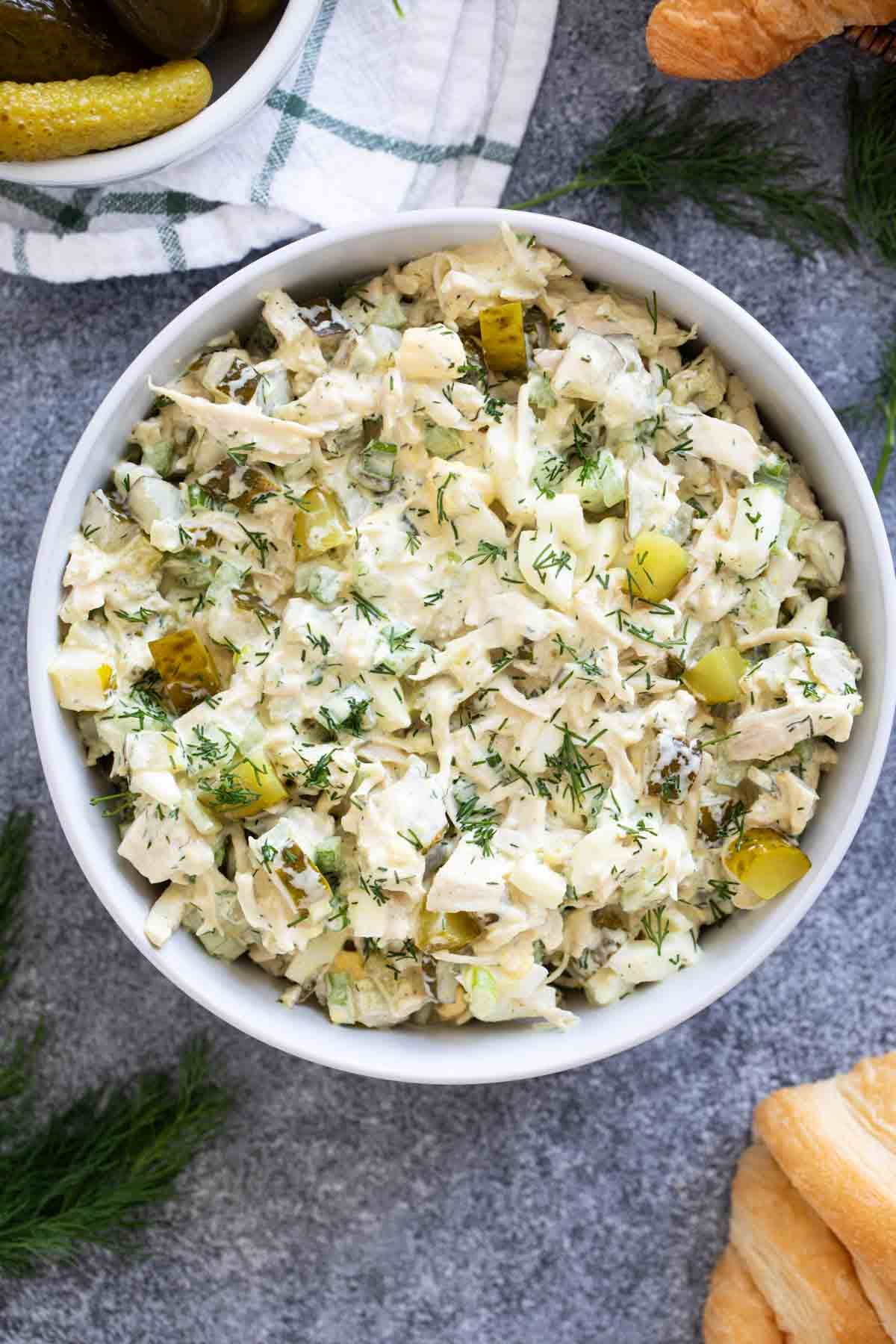 Bowl filled with Pickle Chicken Salad with fresh dill on top.