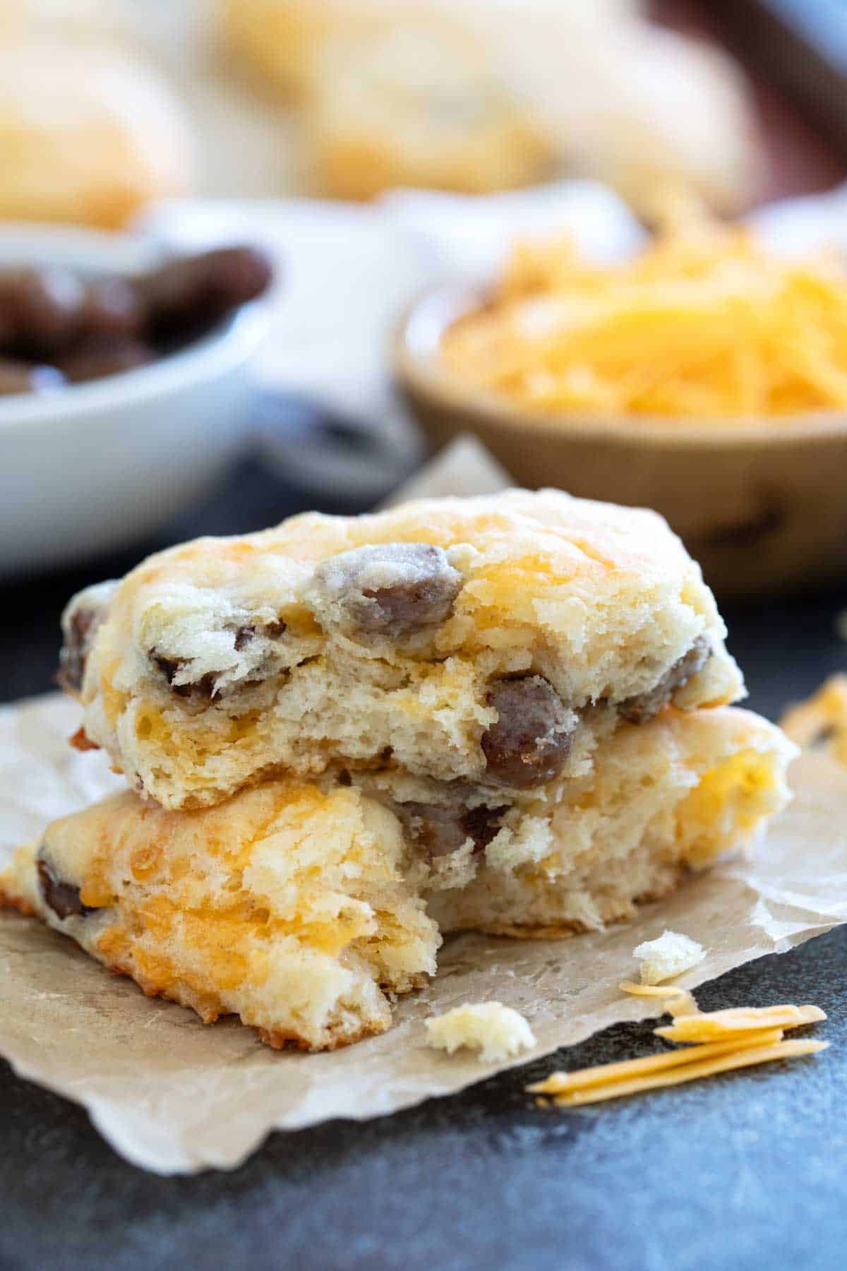 Sausage and Cheese Biscuit torn in half with halves stacked on top of each other.