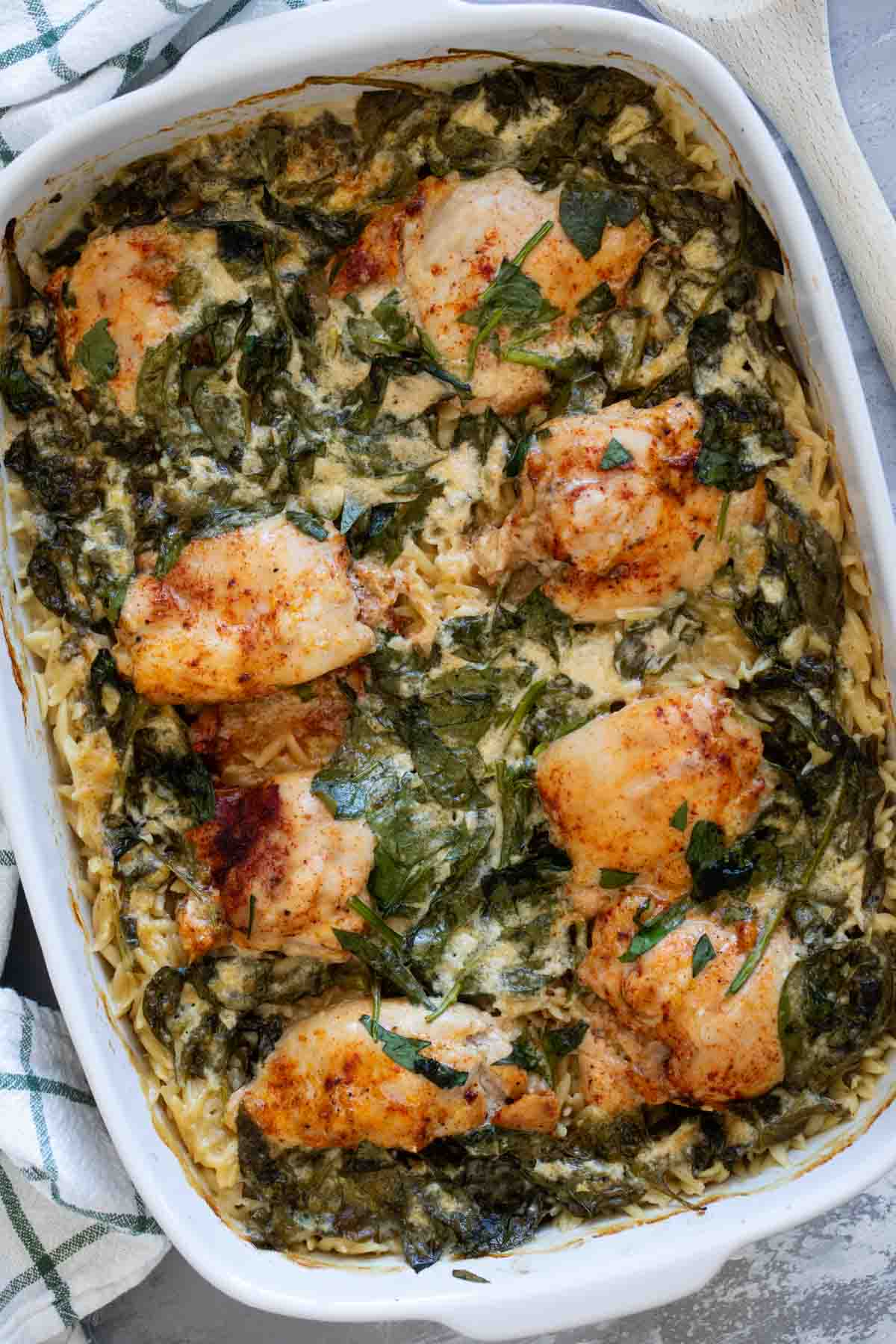 Chicken Orzo Bake with spinach in a casserole dish.