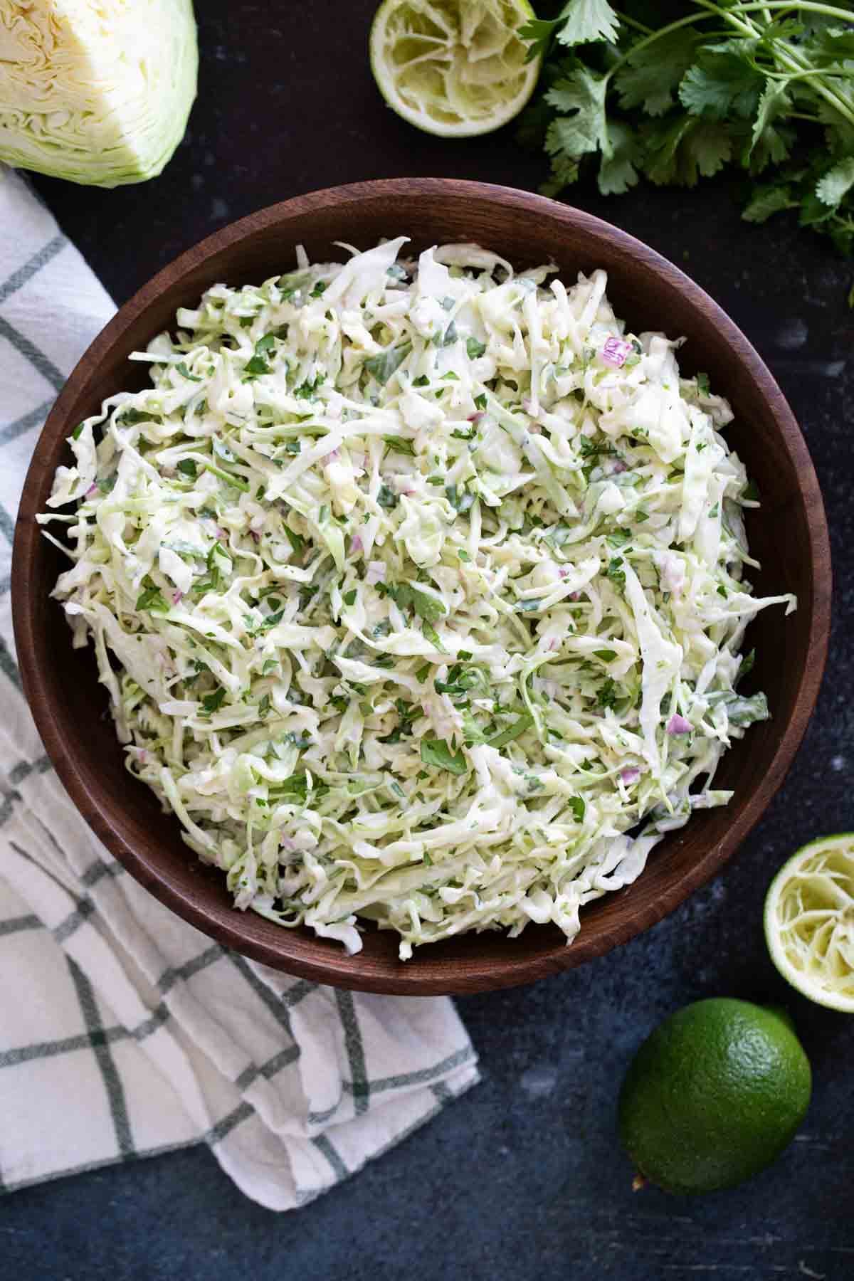 Wooden bowl filled with Cilantro Lime Slaw.