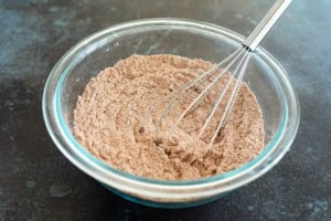 Mixing together dry ingredients for Double Chocolate Oatmeal Cookies.