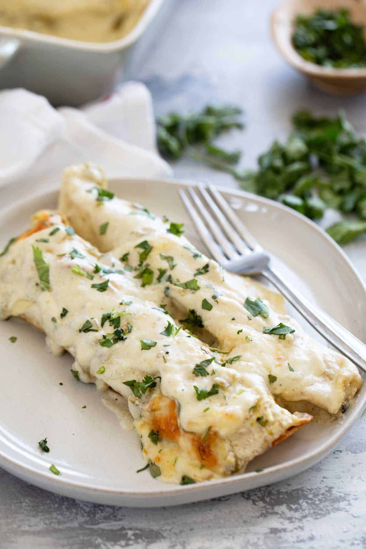 White Chicken Enchiladas on a plate.