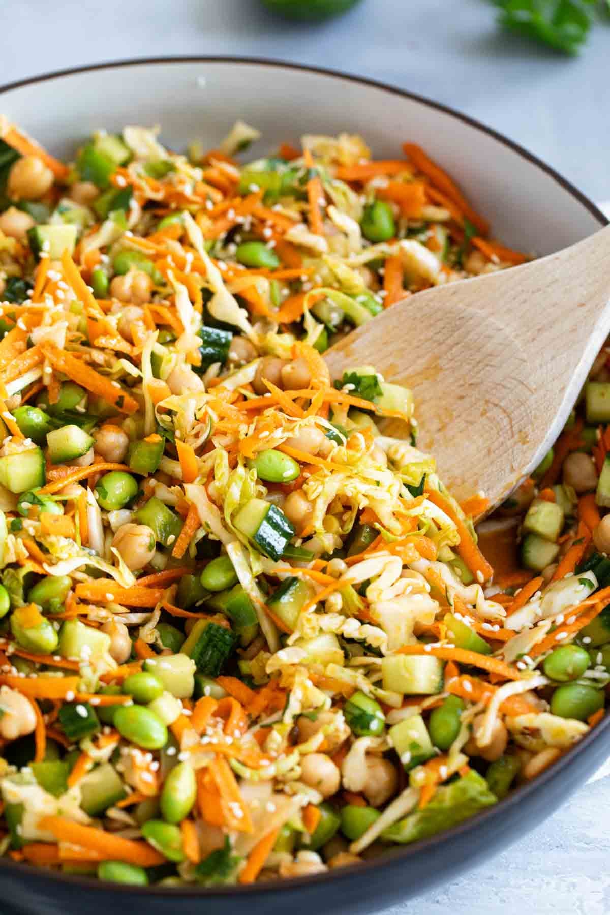 Asian Bean Salad with a wooden spoon in the bowl.