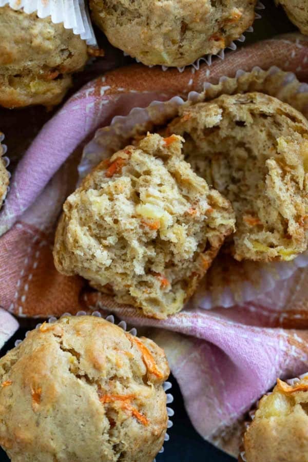 Carrot Pineapple Muffins with one muffin torn in half.