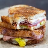 Italian Grilled Cheese sandwich cut in half and stacked, with a bite taken from one half.