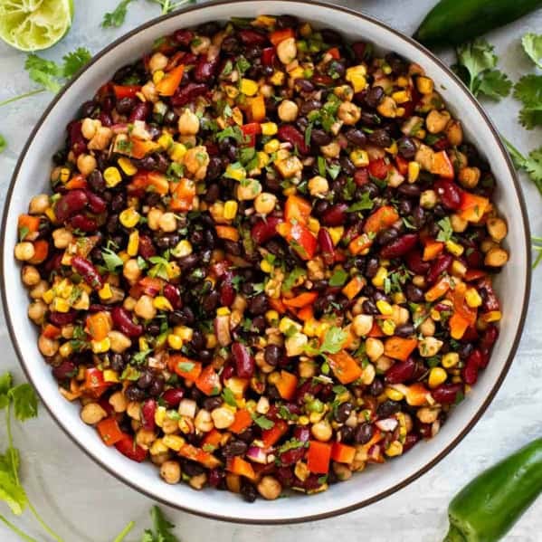Bowl of Mexican Bean Salad with three kinds of beans and vegetables.
