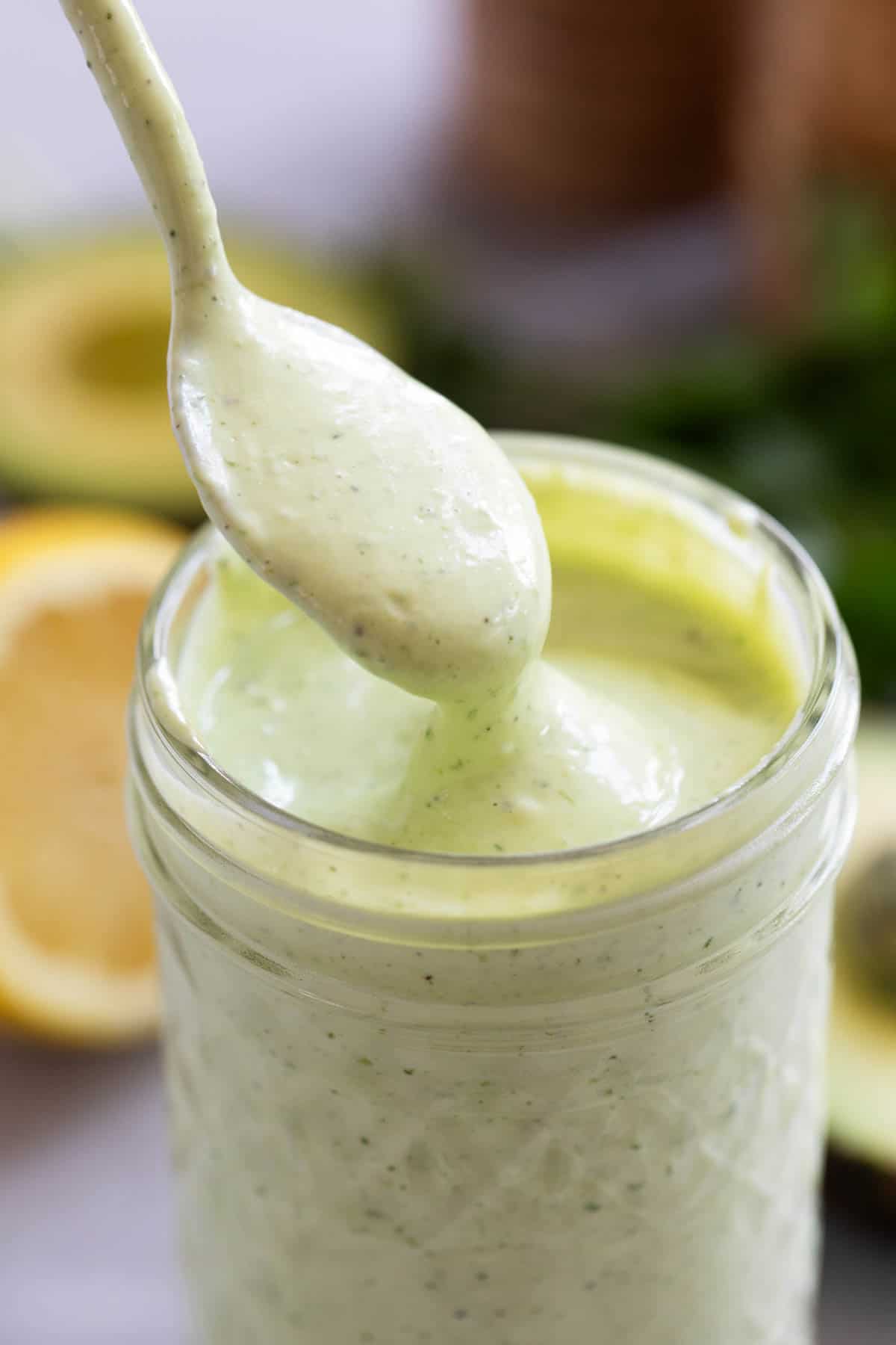 Spoon in a jar of Avocado Ranch Dressing.