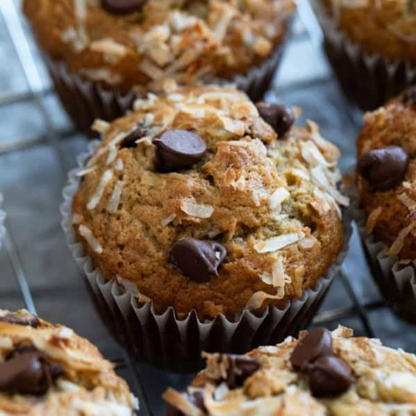 Banana Chocolate Chip Muffins with Coconut, topped with extra chocolate chips and coconut.