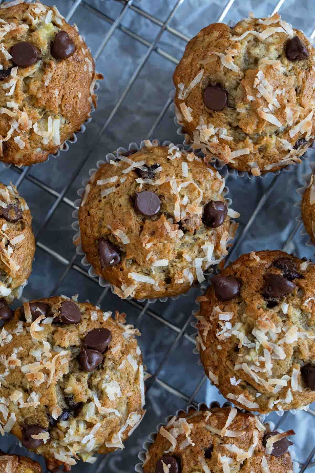 Banana Chocolate Chip Muffins with Coconut on a cooling rack.