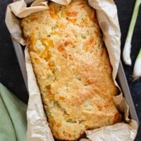 Loaf of Cheddar Black Pepper Quick Bread in a loaf pan.