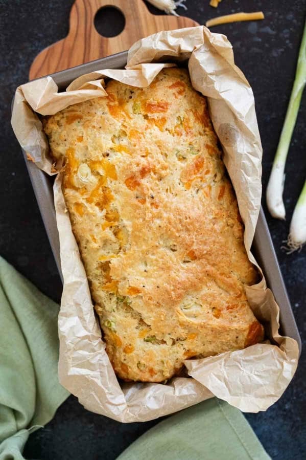 Loaf of Cheddar Black Pepper Quick Bread in a loaf pan.