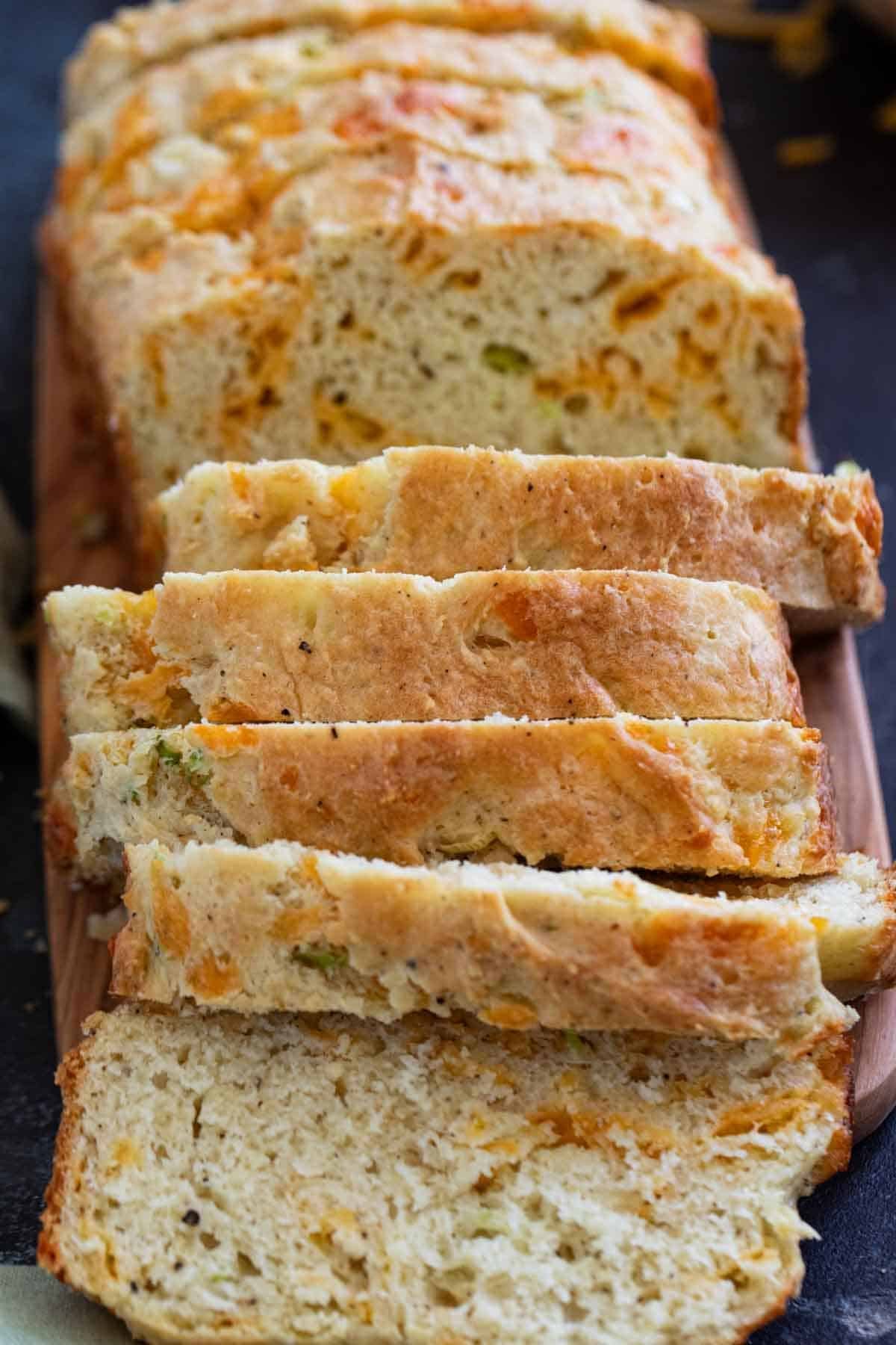 Loaf of Cheddar Black Pepper Quick Bread cut into slices.