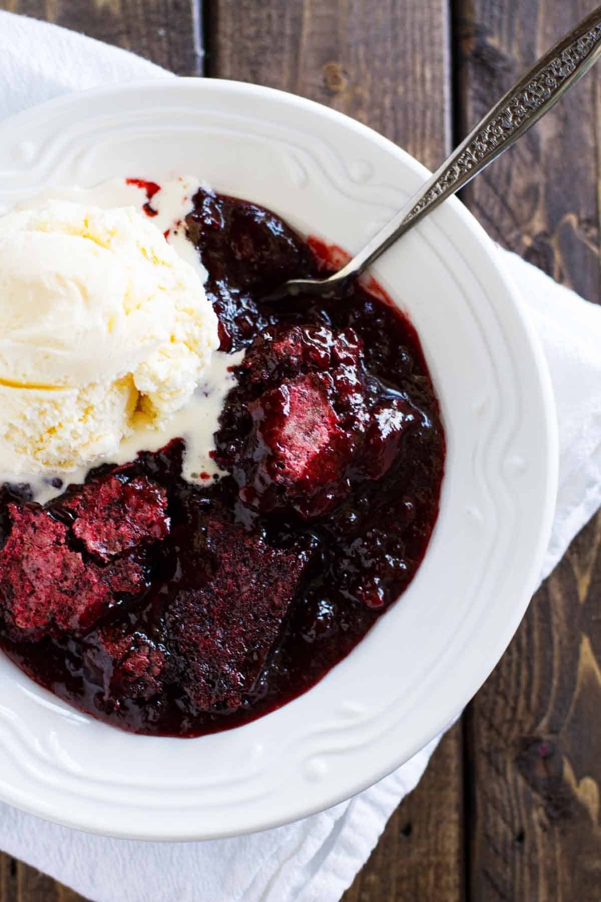 Red Velvet Cobbler in a bowl with a scoop of ice cream.