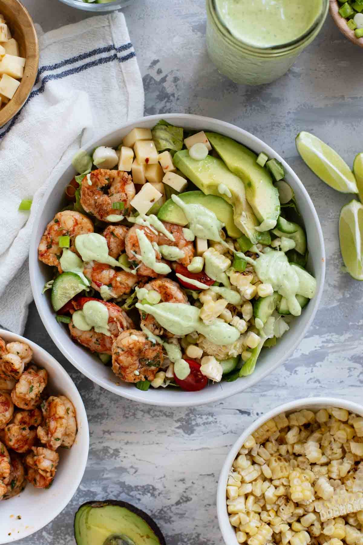 Bowl of Shrimp and Corn Salad topped with Avocado Ranch Dressing.