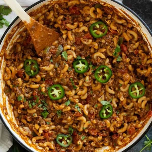 Skillet filled with Taco Pasta topped with jalapeños and cilantro.