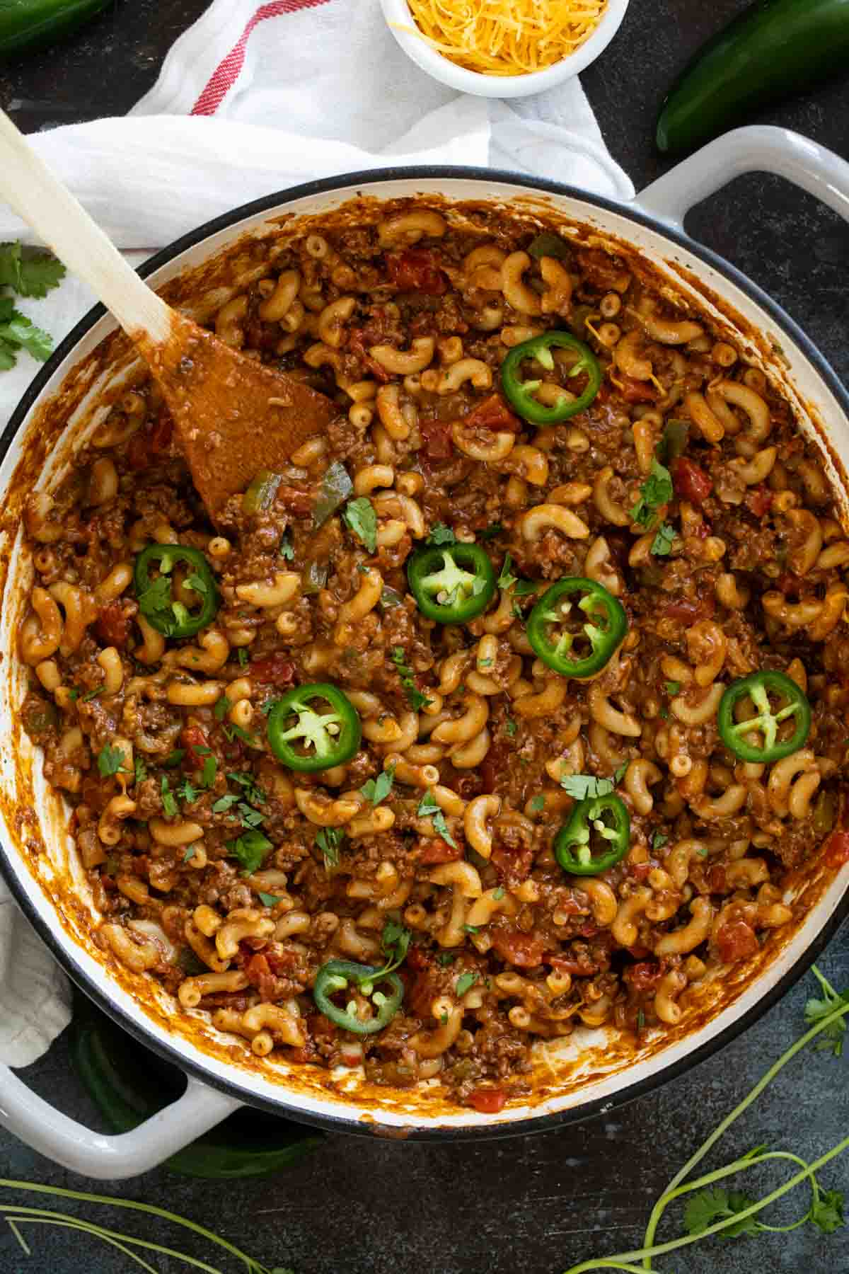 Skillet filled with Taco Pasta topped with jalapeños and cilantro.