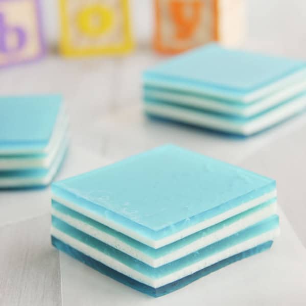 Slices of Baby Blue Layered Jello with building blocks behind spelling out boy.