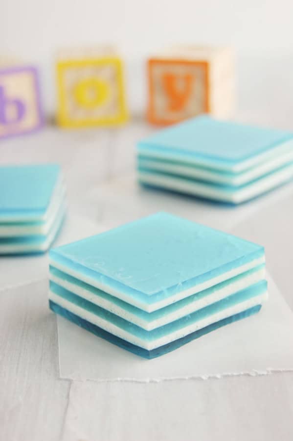 Slices of Baby Blue Layered Jello with building blocks behind spelling out boy.