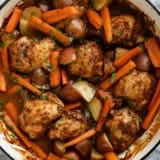 Large skillet with Braised Chicken Thighs with Carrots and Potatoes.