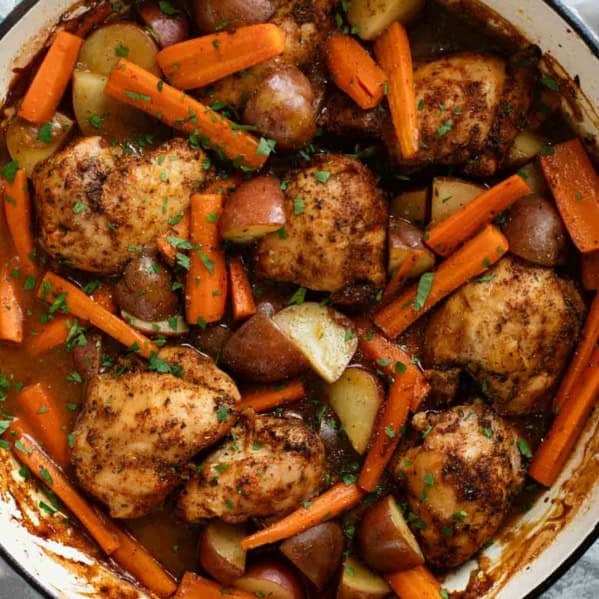 Large skillet with Braised Chicken Thighs with Carrots and Potatoes.