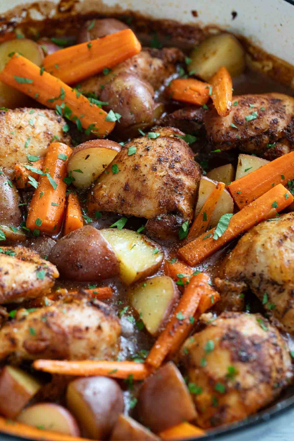 Skillet with Braised Chicken Thighs with Carrots and Potatoes.