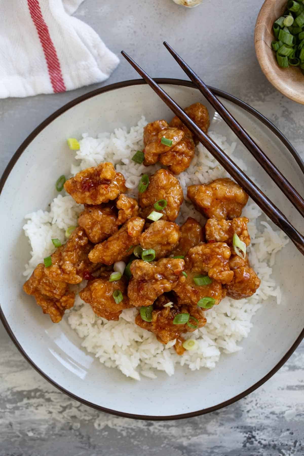 Chicken Oriental over rice, topped with green onions.