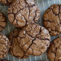 Coconut Brownie Cookies stacked on a cooling rack.