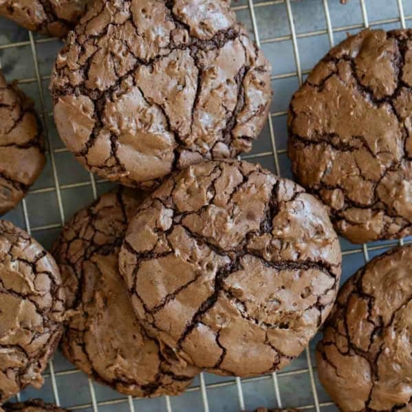Coconut Brownie Cookies stacked on a cooling rack.