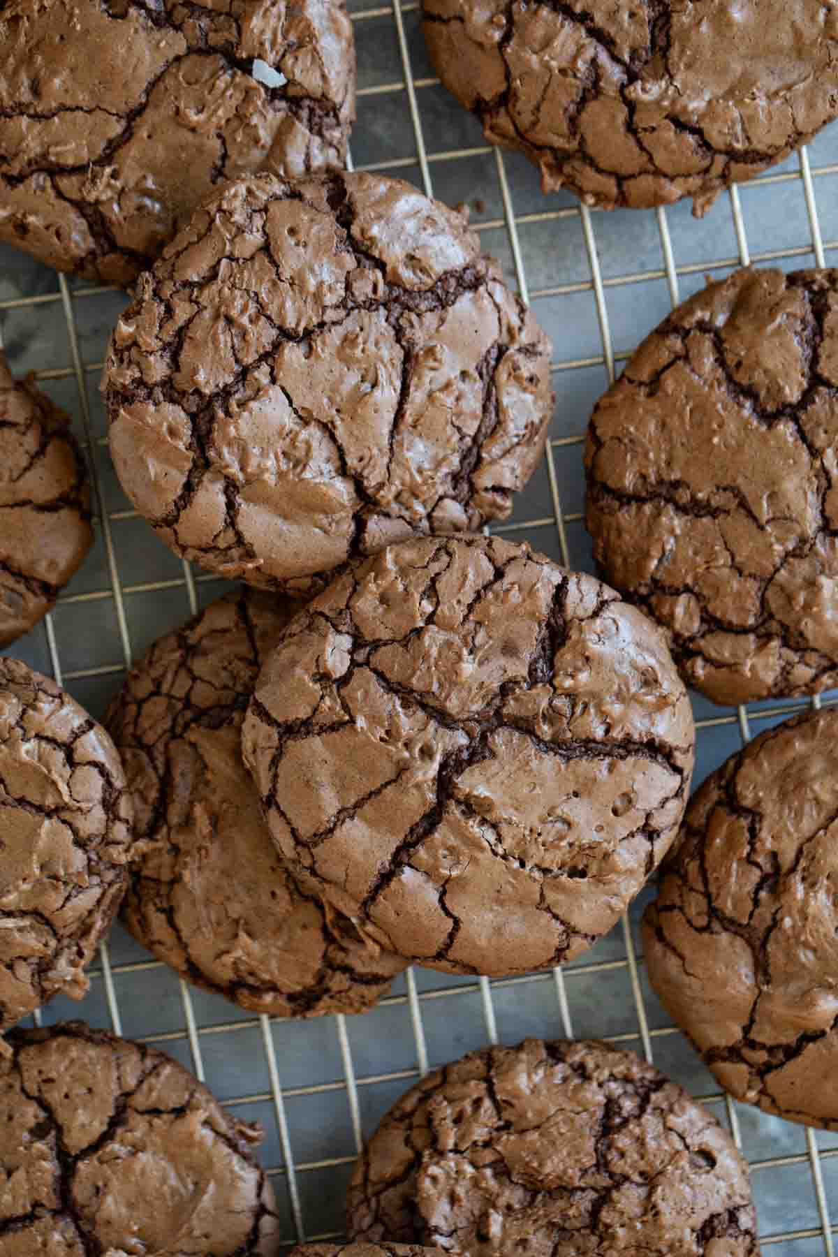 Coconut Brownie Cookies stacked on a cooling rack.