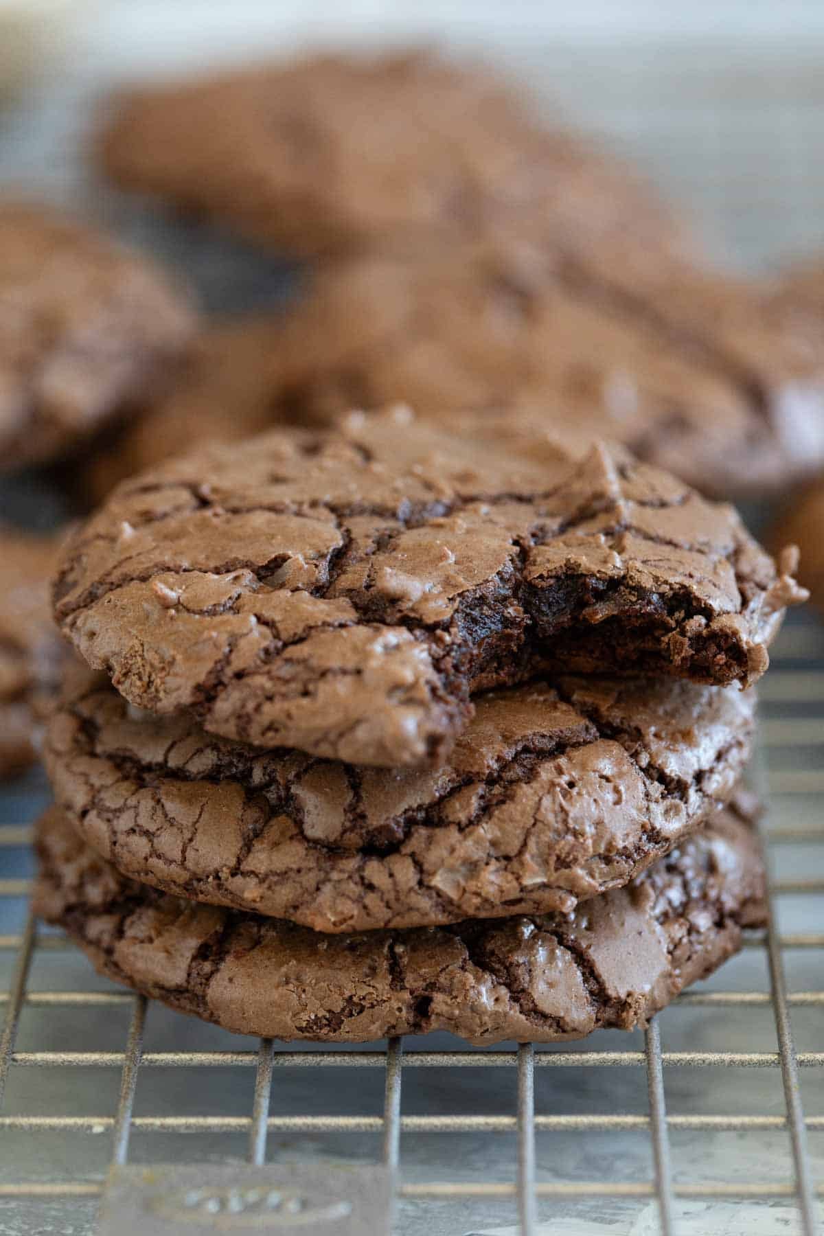 Coconut Brownie Cookies stacked on top of each other, with a bite taken from one.