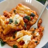 Serving of Crock Pot Baked Ziti topped with fresh basil.