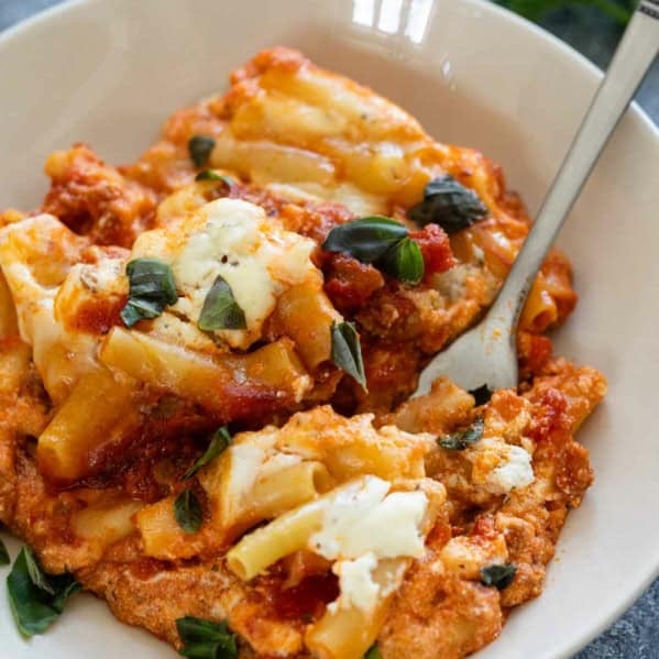 Serving of Crock Pot Baked Ziti topped with fresh basil.