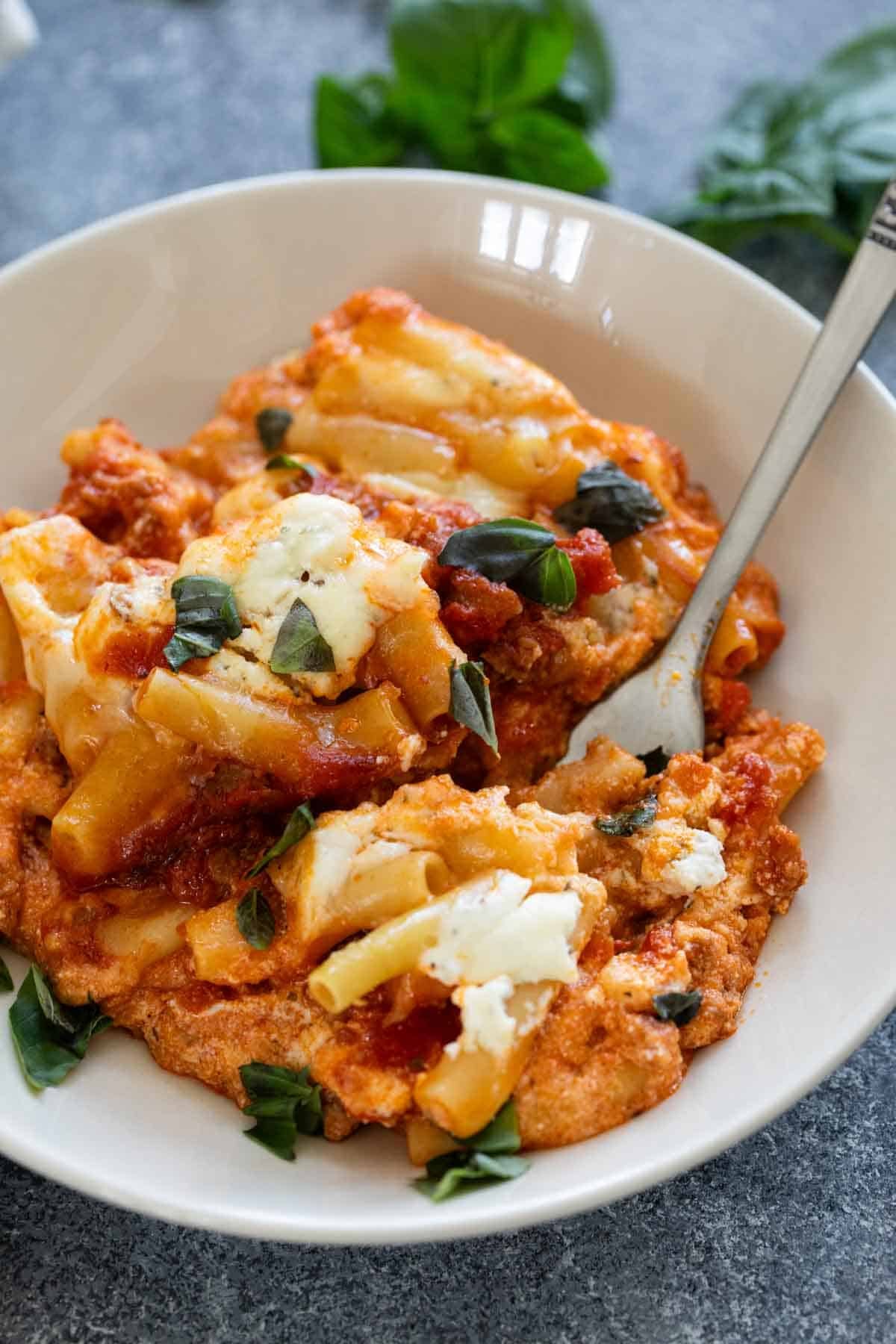 Serving of Crock Pot Baked Ziti topped with fresh basil.