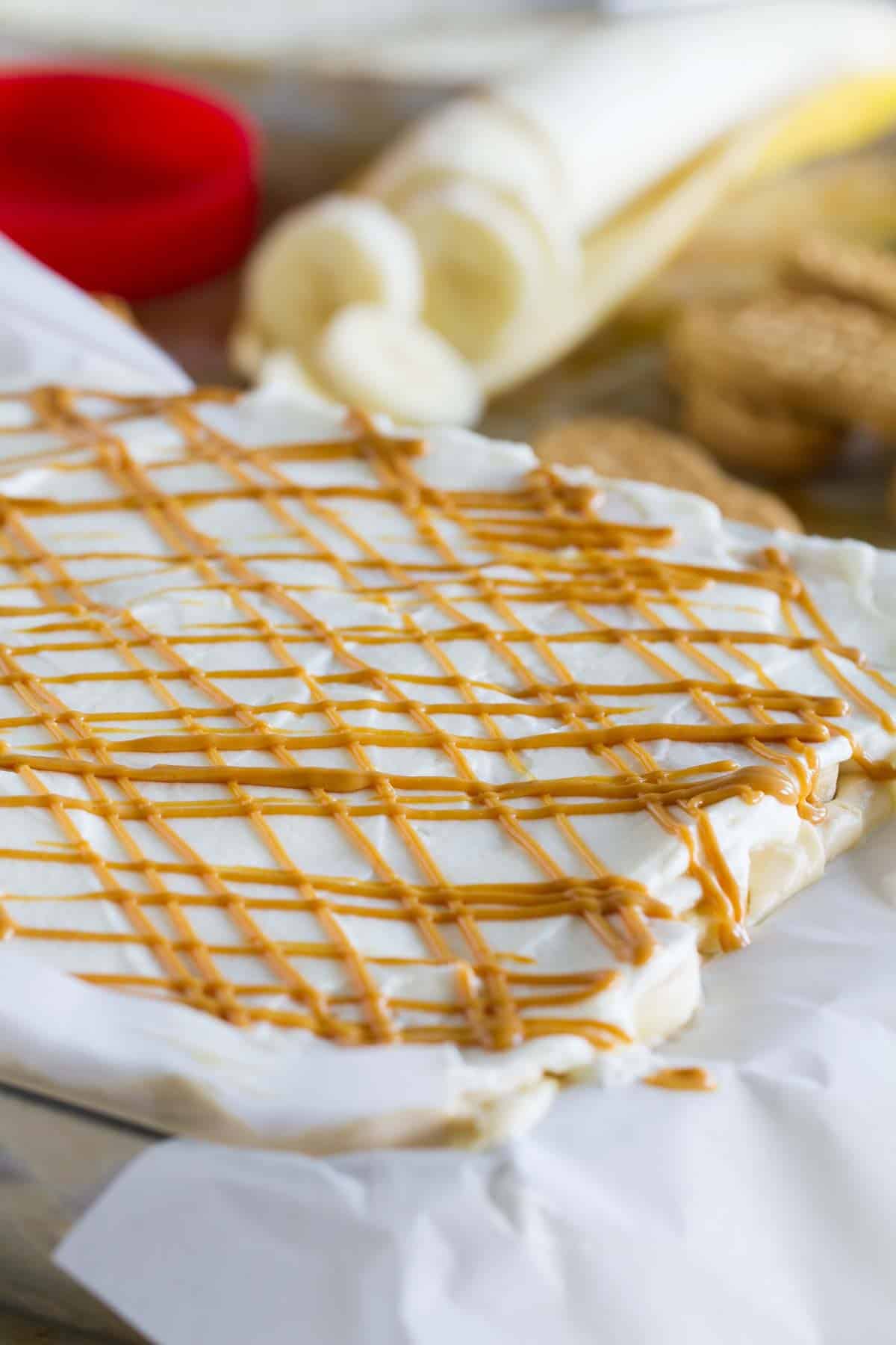 Peanut Butter Banana Icebox Cake with peanut butter drizzled over the top.