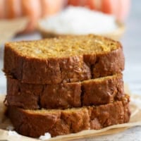 Slices of Pumpkin Coconut Bread stacked on top of each other.