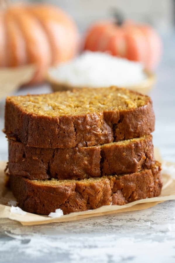 Slices of Pumpkin Coconut Bread stacked on top of each other.