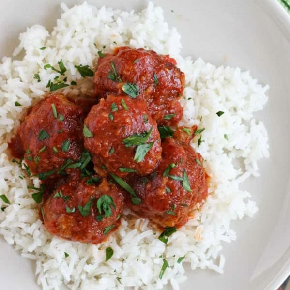 Tamale Balls served over rice.