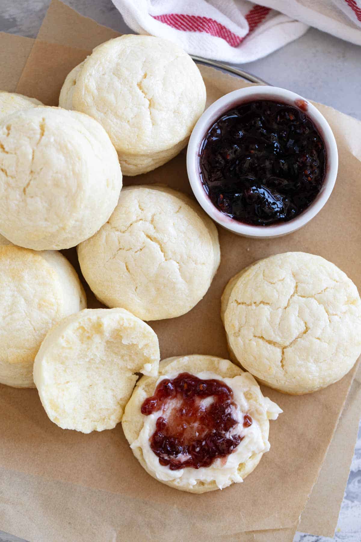 Cream Biscuits with one cut in half and spread with butter and jam.
