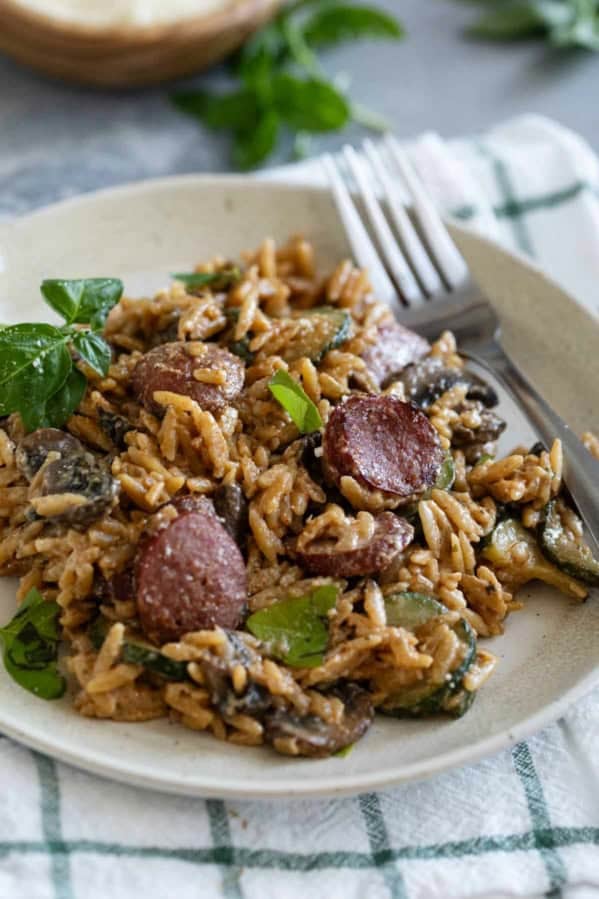 Creamy Orzo with Smoked Sausage, topped with basil and parmesan cheese.