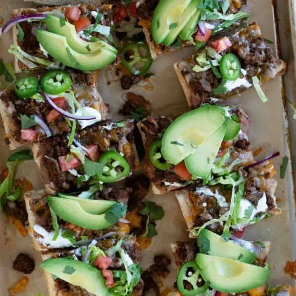 Taco French Bread Pizza topped taco toppings and cut into slices.