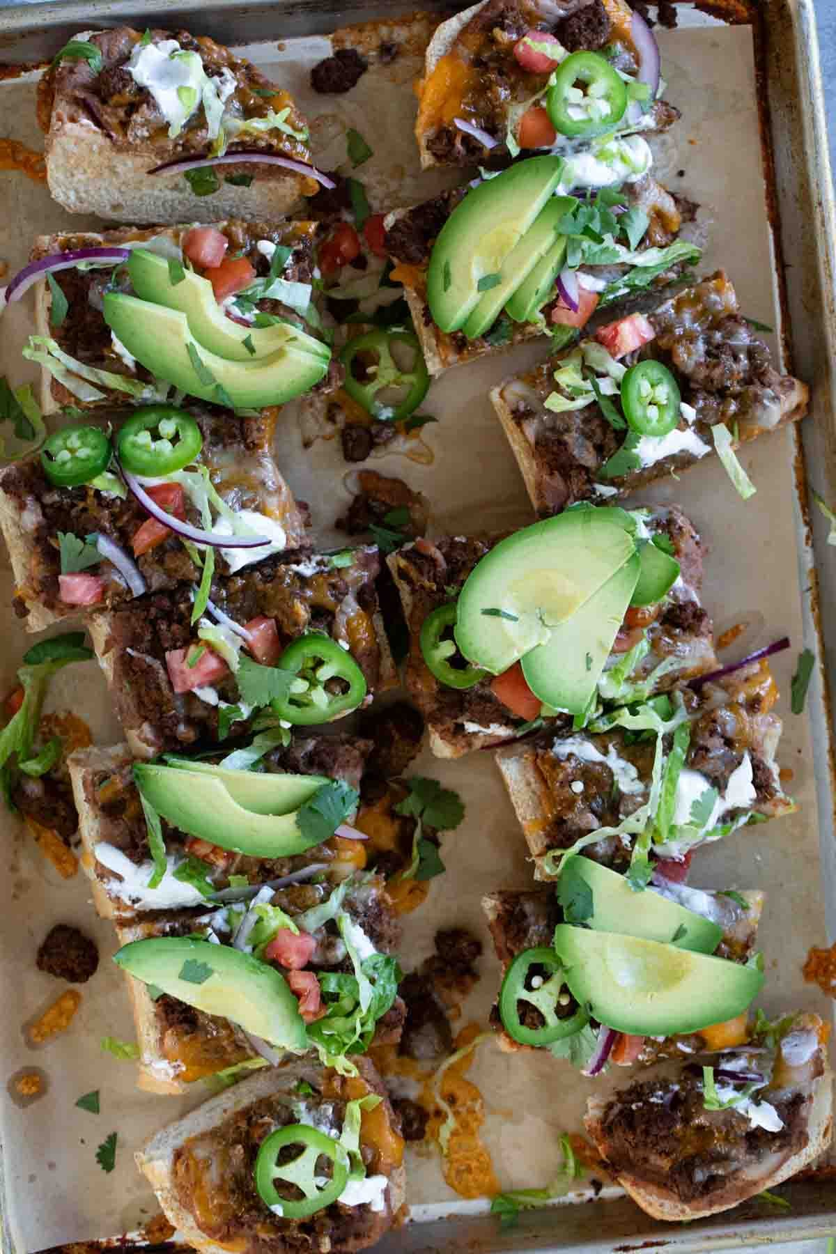 Taco French Bread Pizza topped taco toppings and cut into slices.